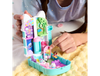 A child playing with a Gabby's Dollhouse Purrfect Playset on a yellow blanket.