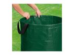 Hands adjusting the top of a green garden waste bag on a lawn.