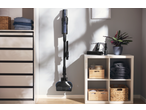 SILVERCREST® Cordless Cyclone Handheld Vacuum Cleaner mounted on a wall in a tidy room.
