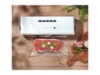 SilverCrest vacuum sealer with steak, rosemary, and garlic on a wooden table