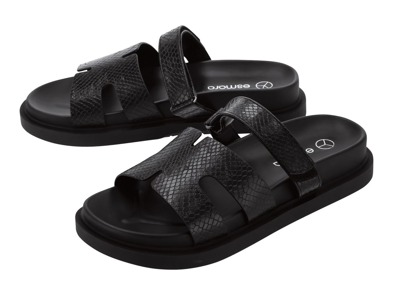Pair of black sandals with a snakeskin texture and thick soles.