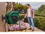 Parkside hose reel and gardener watering flowers.