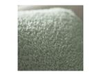 Close-up of a soft, light green fuzzy blanket or towel.