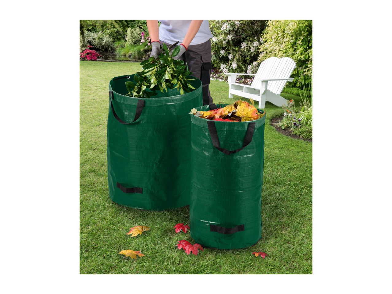 Two green garden waste bags filled with leaves and branches on a lawn