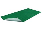 Green artificial grass carpet with a non-slip backing, partially rolled up.