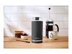 SilverCrest coffee grinder, French press, and coffee beans on a wooden counter.