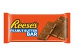Orange wrapper for a peanut butter chocolate bar, with two bars showing the peanut butter filling.