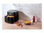 Silvercrest air fryer with fries, ketchup, and mayonnaise on a wooden counter.
