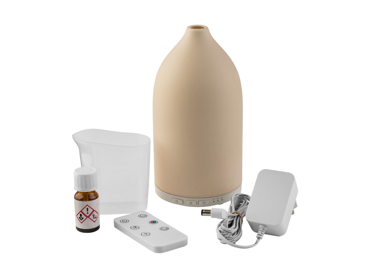 Aromatherapy diffuser set with essential oil, measuring cup, remote control, and power adapter.
