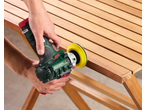 Handheld sander renews a wooden garden furniture.