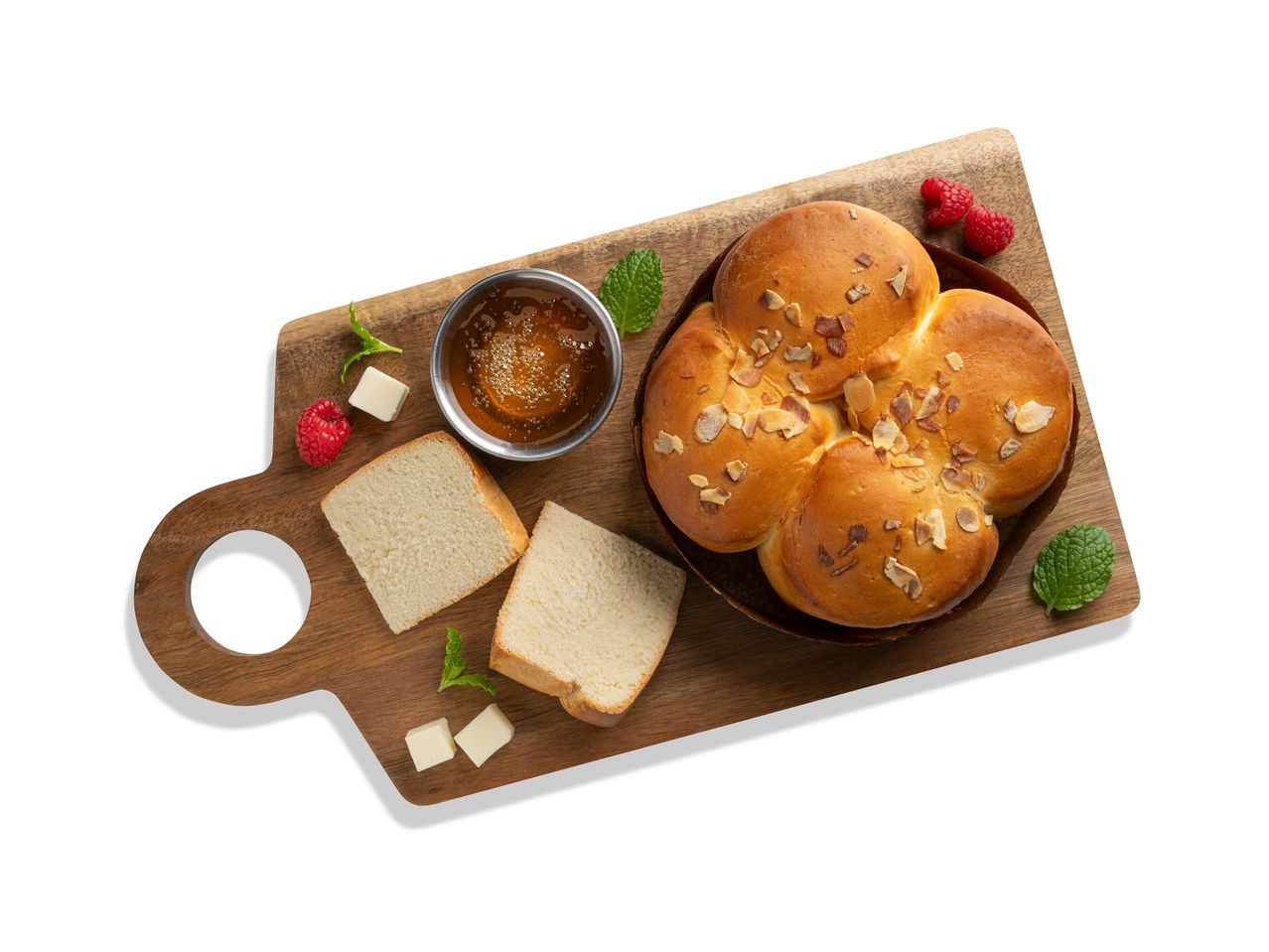 Kenyér, méz és málna fa deszkán.