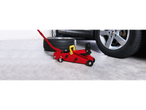 Tire, jack, and wheel in a garage.