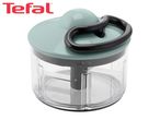 Manual food chopper with a light green lid, black pull handle, and clear bowl.