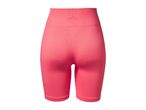 Coral pink ribbed cycling shorts with a high waist and subtle pattern on the waistband.