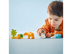 Child playing with toy lion and penguin figures, with building blocks.