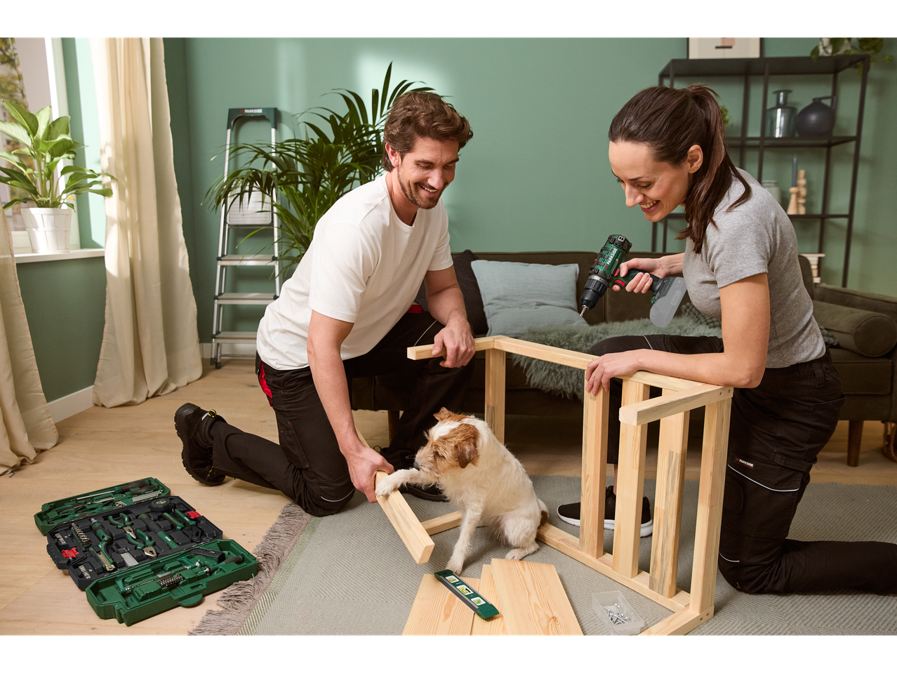 Couple assembling furniture with a Parkside drill and tools.