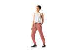 Woman in CRIVIT Ladies' Joggers and a white tank top, standing with hands in pockets.