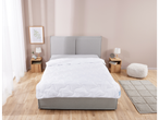 White quilted duvet on a bed in a bedroom.