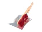 A red brush with a wooden handle resting on a silver dustpan.