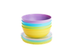 A stack of colorful Munchkin feeding bowls with lids.