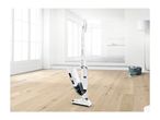 A Bosch Readyy'y Serie | 2 cordless stick vacuum cleaner stands on a light wood floor in a modern home.