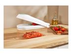 A vegetable chopper with diced tomatoes on a wooden countertop.