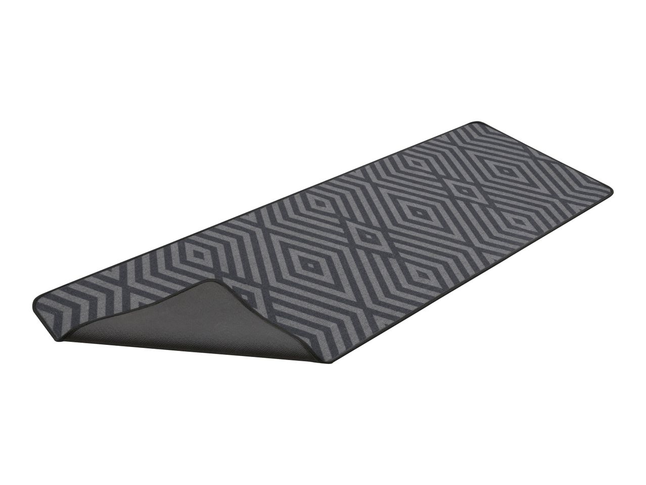 Grey runner rug with a geometric diamond pattern, partially curled to show the underside.