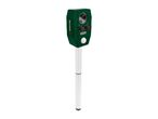 Green animal repeller with a solar panel and controls, mounted on a white stake.