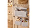 Chrome wire shelving unit with various storage bins and cleaning supplies.