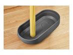 Spaghetti pasta in a gray measuring tool on a wooden surface.