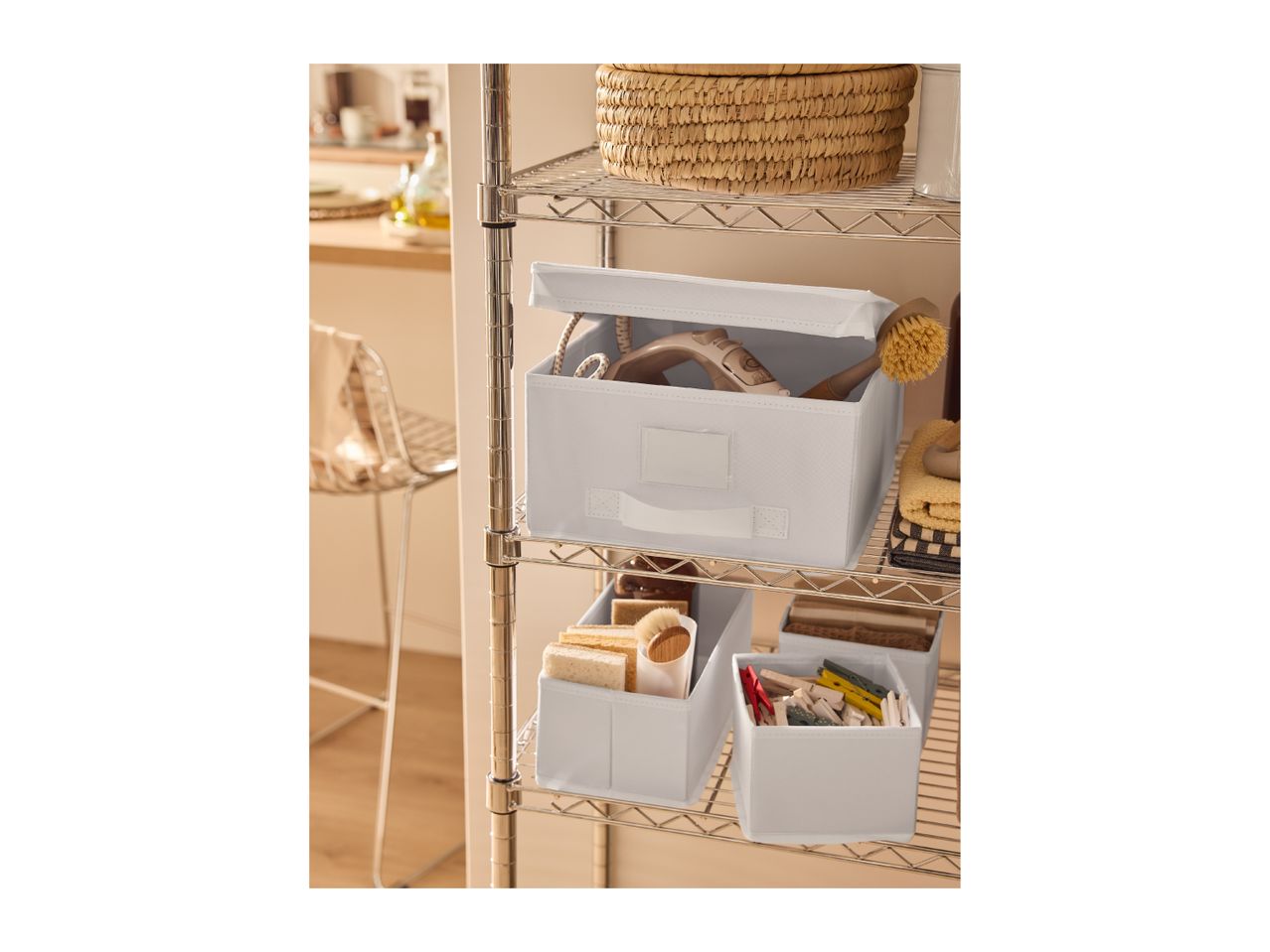Chrome wire shelving unit with various storage boxes and household items.