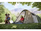 Family camping with a CRIVIT 4 Person Family Tent, mountains in the background.