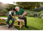 Older man and boy building a wooden bench using a Parkside drill.