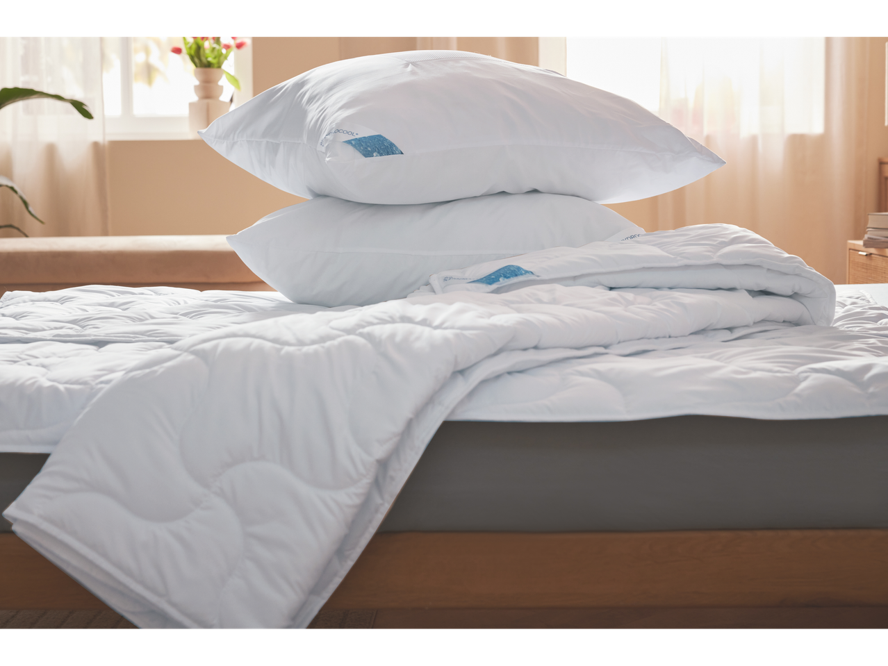 Pillows and duvet on a bed.