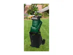 A person feeding green branches into a garden shredder with a collection bag.