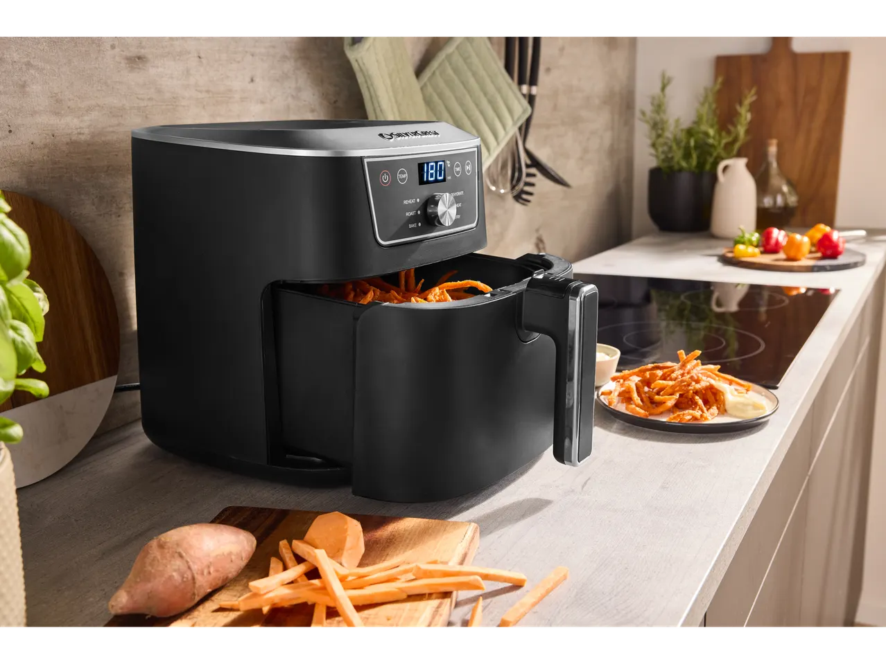 SILVERCREST® XL Air Fryer cooking sweet potato fries in a kitchen setting.