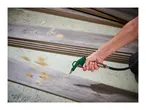Person using a Parkside air blow gun to clear sawdust from laminate flooring.