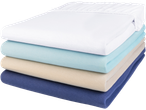 A stack of four fitted sheets in white, light blue, beige, and navy blue.