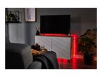 Living room with a TV on a white cabinet, illuminated by red LED strip lights.