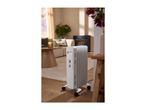 White oil-filled radiator on wheels in a cozy living room setting.