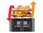 Air fryer with salmon and vegetables, showing air circulation with arrows.