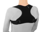 Rear view of a person wearing a black posture corrector over a white long-sleeved shirt.