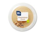 En rund beholder med Chef Select klassisk hummus med sesam og kikærter.