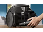 Philips Bagged Vacuum Cleaner with a hand inserting a component