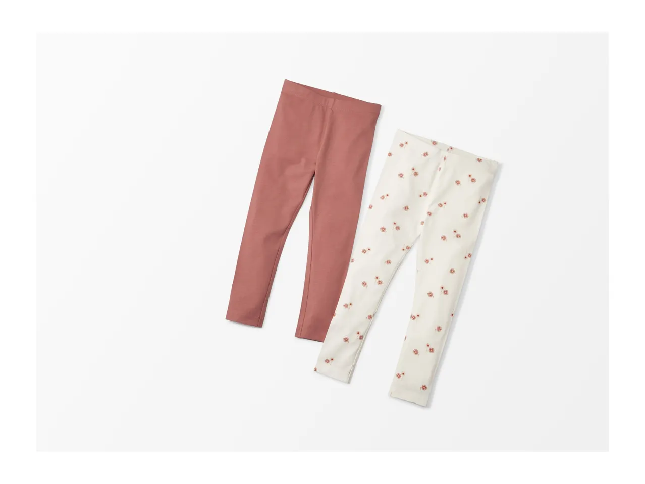 Two pairs of baby leggings, one solid dusty rose and one cream with a floral print.