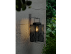 LIVARNO home LED Solar Lantern with geometric cutouts, casting warm light on a textured wall.