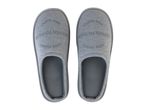 A pair of gray slippers with the text 'GOOD THINGS HAPPEN TO THOSE WHO HUSTLE'