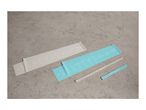 Two resistance bands with exercise illustrations and two smaller bands on a concrete surface.