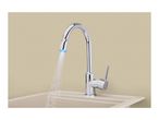 Chrome kitchen faucet with blue LED light water stream over a beige sink.