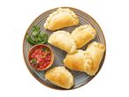 Six golden-brown empanadas served on a plate with salsa.